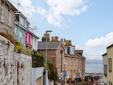 A street view with houses and signs at Captains Cottage in Brixham