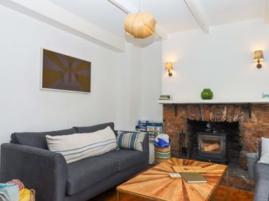 A living room featuring a sofa and coffee table at Captains Cottage in Brixham