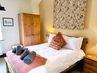 A bedroom with a bed and wardrobe at Bush Nook House in Brampton