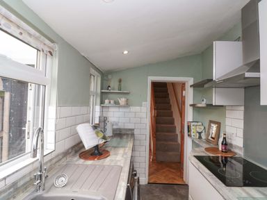 A kitchen with a sink and stove at Moot Cottage in Driffield