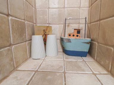 Decorative items including vases and a boat on tiles