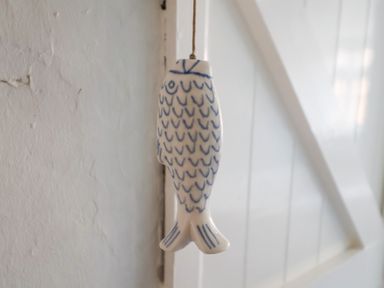 A fish decoration hanging on a wall at Buttercup in Blakeney, Norfolk