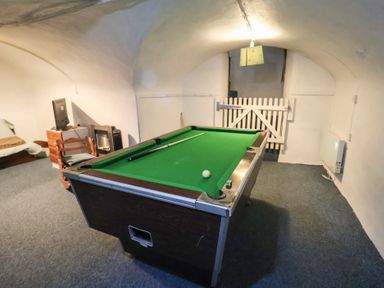 A game room with a pool table and seating at Buttercup in Blakeney, Norfolk