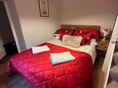 A bedroom with a bed and bedside table at The Bittern in Blakeney, Norfolk