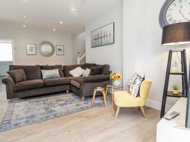 A living room with a sofa and side table at Beach Hideaway