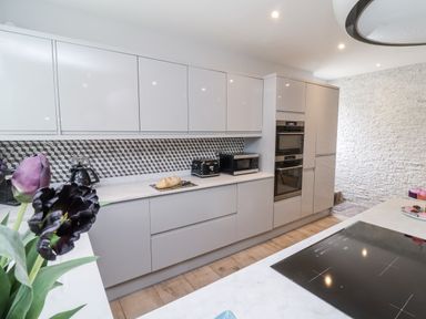 A kitchen with cabinets and appliances at Beach Hideaway