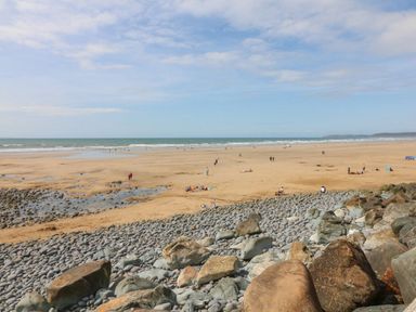 A beach view with people and rocks at Beach Hideaway