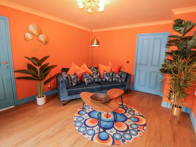 A living room with a blue sofa and a coffee table at Annexe in East End near Brantham