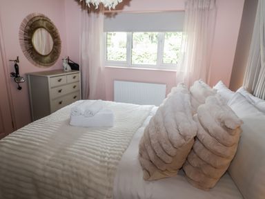 A bedroom with a bed and dresser at Annexe East End near Brantham