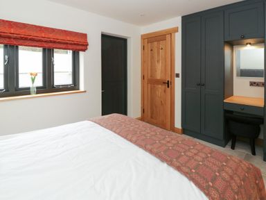 A bedroom with a bed and a window at The Barn at Sunny Barn in Brecon