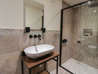 A bathroom with a sink and shower at The Barn at Sunny Barn in Brecon