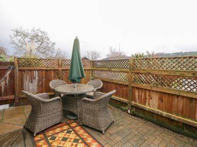 An outdoor area with a table and chairs at The Barn at Sunny Barn in Brecon