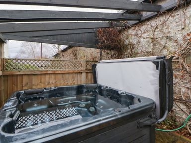 A hot tub in an outdoor space at The Barn at Sunny Barn in Brecon