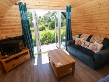 A living room with a sofa and TV at Lodge 2 near Pontyates