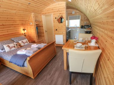 A studio with a bed and dining table at Lodge 2 near Pontyates