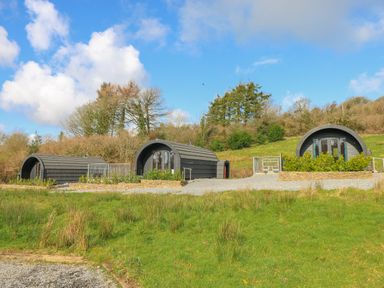 Three cabins on a grassy area near Pontyates