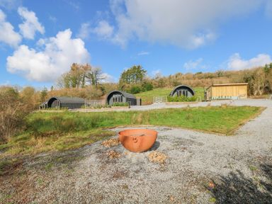 An outdoor area with cabins and fire pit at Lodge 3 near Pontyates