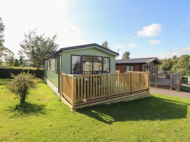 A holiday home with a deck in an outdoor area at Barnes Retreat in Carnforth