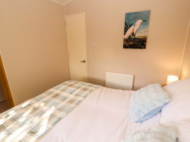 A bedroom with a bed and door at Barneys Retreat in Carnforth