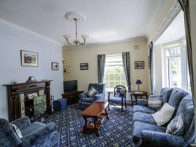 A living room with sofa and TV at Knockroe Lodge in 