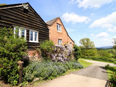 A building with plants and a pathway at Upper Pandy Farm Berriew near Welshpool