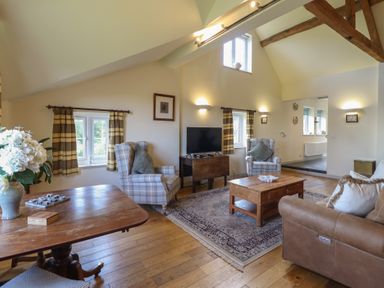 A living room with a sofa and a coffee table at Upper Pandy Farm Berriew near Welshpool