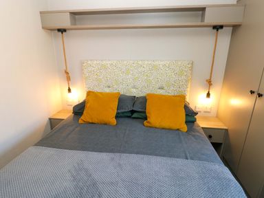 A bedroom with a bed and pillows at No 13 Broadfield Farm Holiday Park, Saundersfoot
