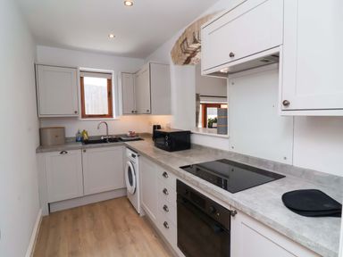 A kitchen with a sink and cabinets at Hedgehog Highway Parkham