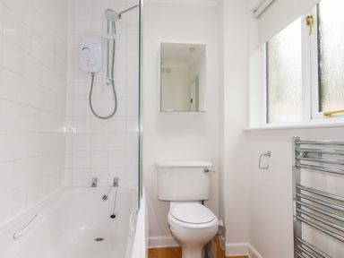 A bathroom with a bathtub and a toilet at Acorns in Falmouth