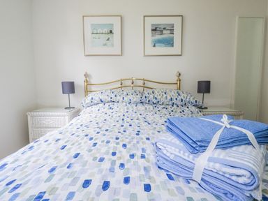 A bedroom with a bed and towels at Acorns in Falmouth