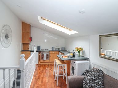 A kitchen with wooden cabinets and appliances at Bobby's in Whitby