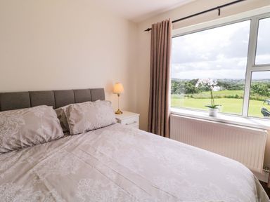 A bedroom with a bed and a view at Ard Na Mara in 
