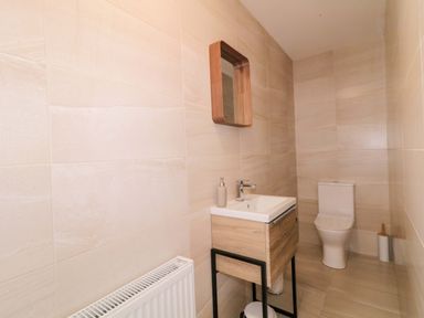 A bathroom with sink, toilet and mirror at Ard Na Mara