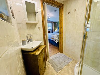 A bathroom with a sink and shower at Harvey's Lodge in Lowertown, Helston