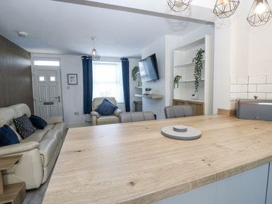 A living room with a sofa and television at Keekle Terrace in Cleator Moor