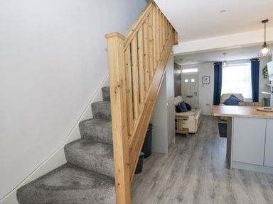 A hallway with a staircase leading to the upper floor at Keekle Terrace in Cleator Moor