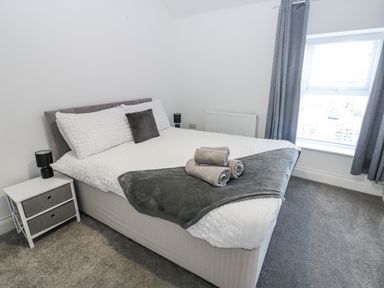 A bedroom with a bed and a bedside table at Keekle Terrace in Cleator Moor
