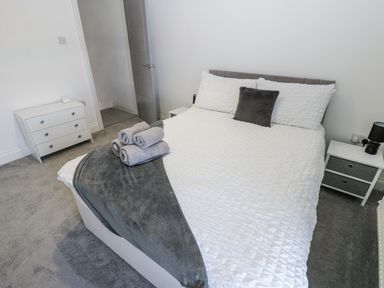 A bedroom with a bed and bedside tables at Keekle Terrace in Cleator Moor