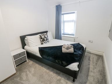 A bedroom with a bed and bedside table at Keekle Terrace in Cleator Moor