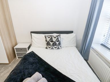 A bedroom with a bed and bedside table at Keekle Terrace Cleator Moor