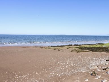 A beach with sand and water at Keekle Terrace in Cleator Moor