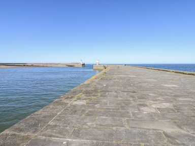 A pier leading into the sea with lighthouses at Keekle Terrace, Cleator Moor