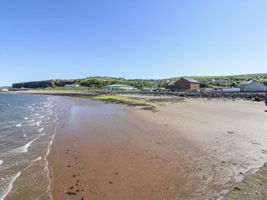A beach with water and hills in the background at Keekle Terrace Cleator Moor