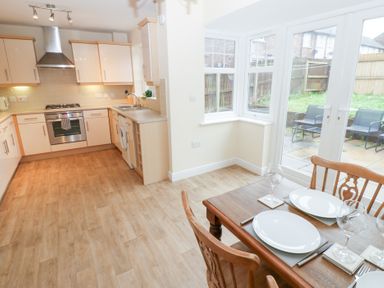 A kitchen with a dining table and chairs at Lingla House in Frizington