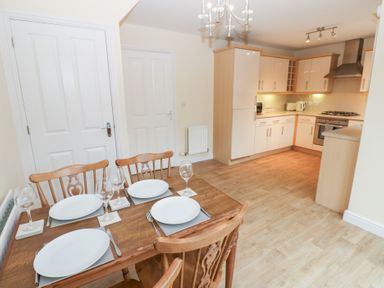 A kitchen with a dining area featuring a table and chairs at Lingla House in Frizington