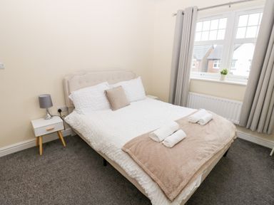 A bedroom with a bed and a bedside table at Lingla House in Frizington
