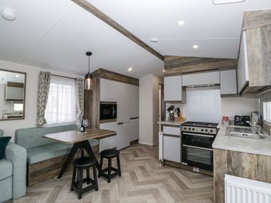 A kitchen with dining area at Puffin in St Bees