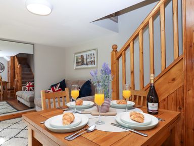 A dining room with a table set for breakfast at Church Barn in Sutcombe near Bradworthy