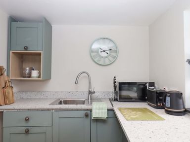 A kitchen with a sink and appliances at Church Barn in Sutcombe near Bradworthy
