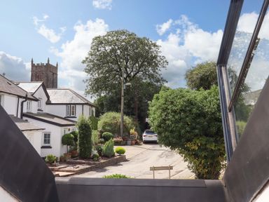 A view of houses and a church at Church Barn Sutcombe near Bradworthy